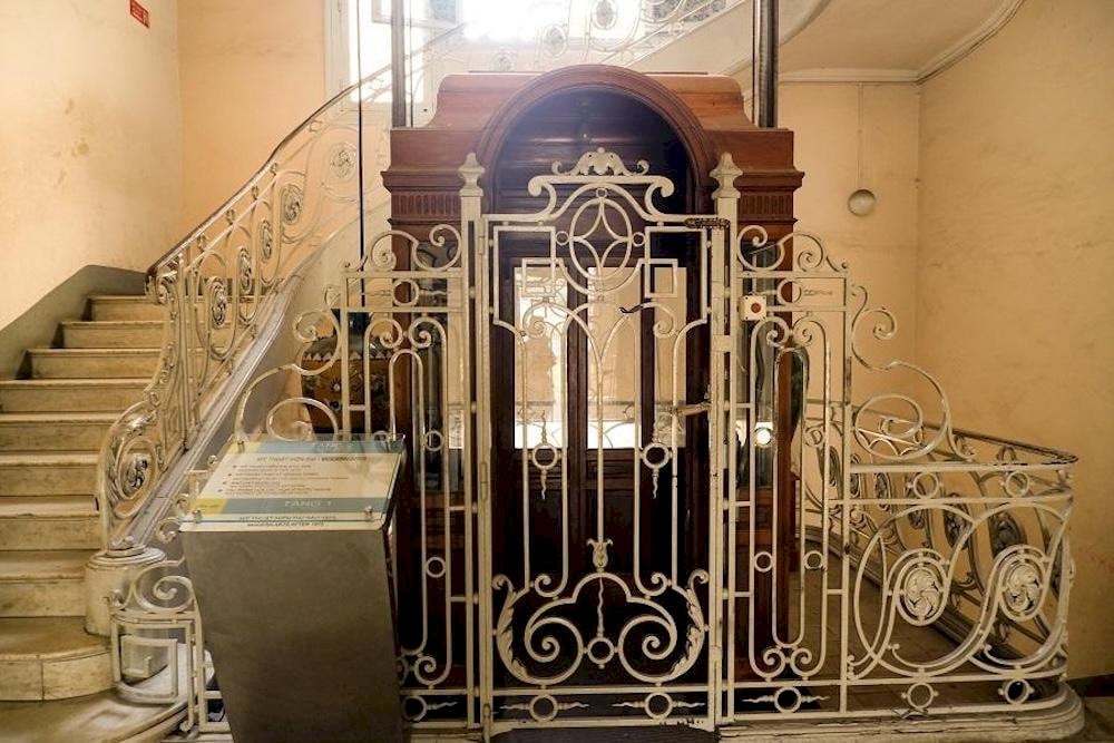 Today, the wooden elevator remains largely unchanged from its original design, standing as a silent witness to the building’s many historical ups and downs